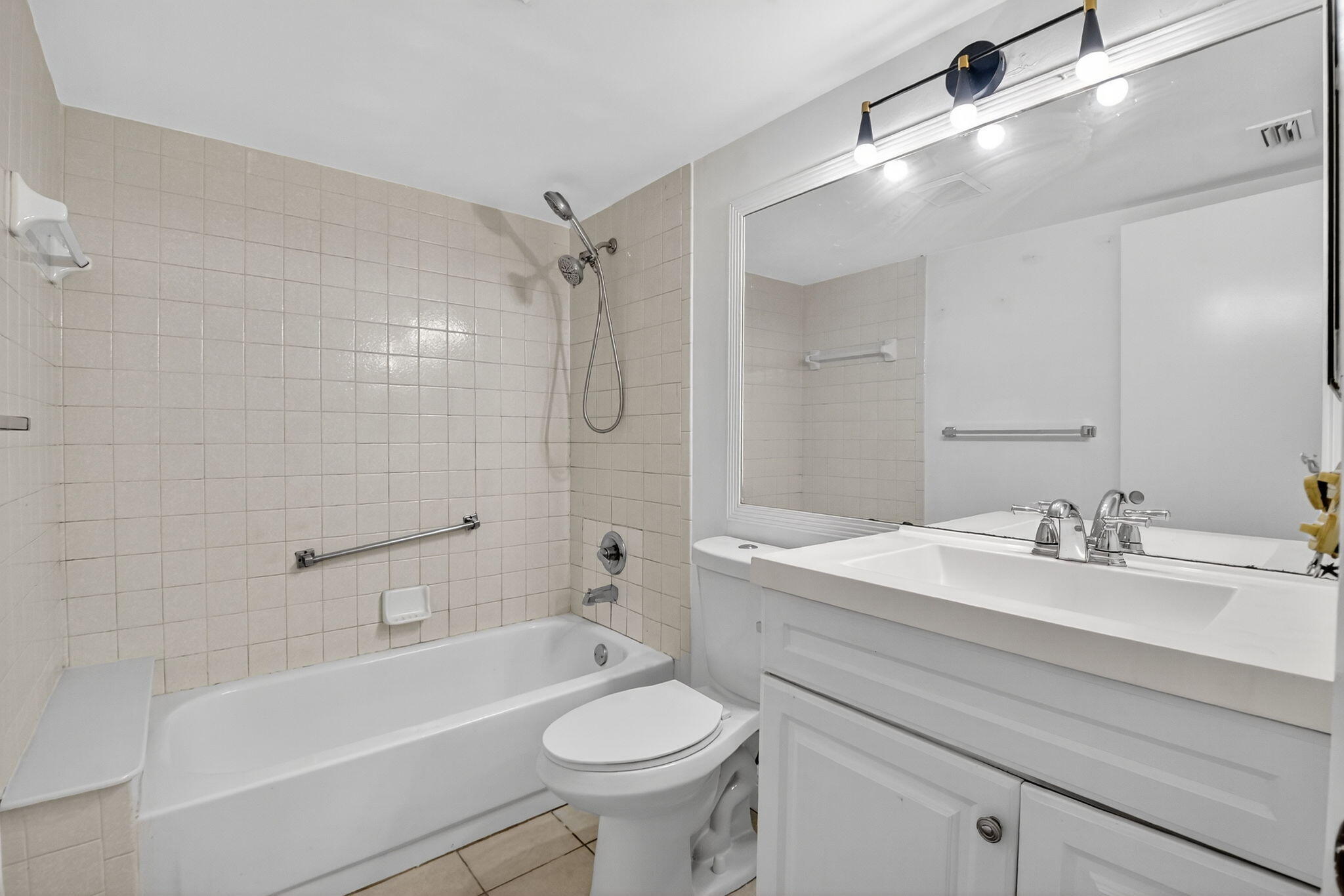 208 Foxtail Drive, Unit B2 Greenacres, FL 33415 - Photo 19 of 33 a bathroom with a sink a toilet and a mirror