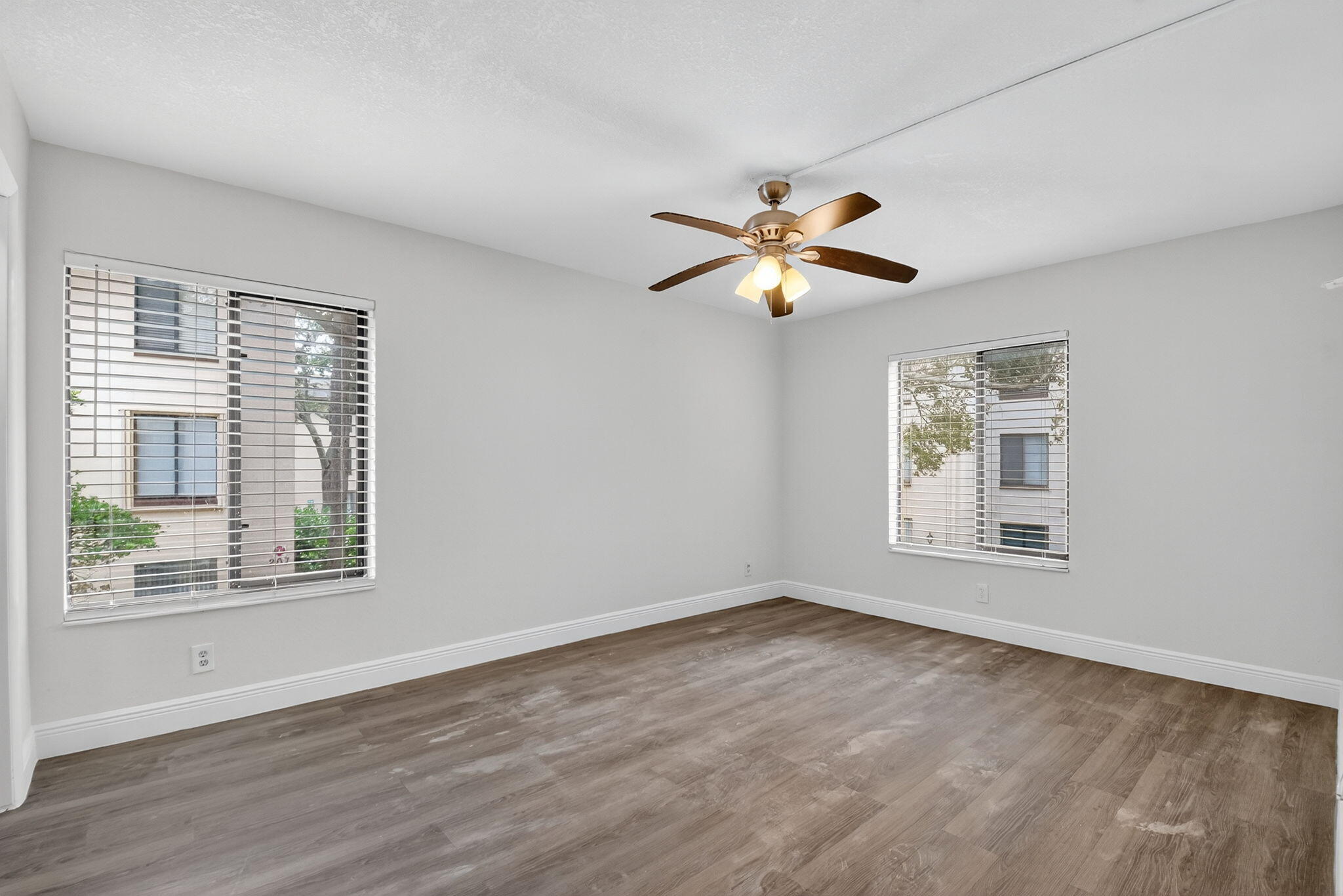 208 Foxtail Drive, Unit B2 Greenacres, FL 33415 - Photo 21 of 33 a view of an empty room with a window and wooden floor