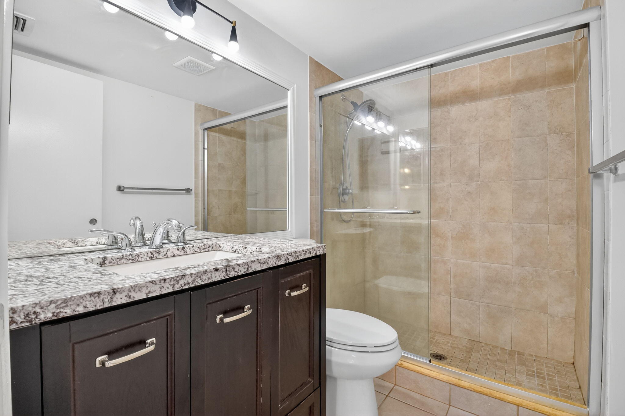 208 Foxtail Drive, Unit B2 Greenacres, FL 33415 - Photo 24 of 33 a bathroom with a granite countertop sink toilet and shower