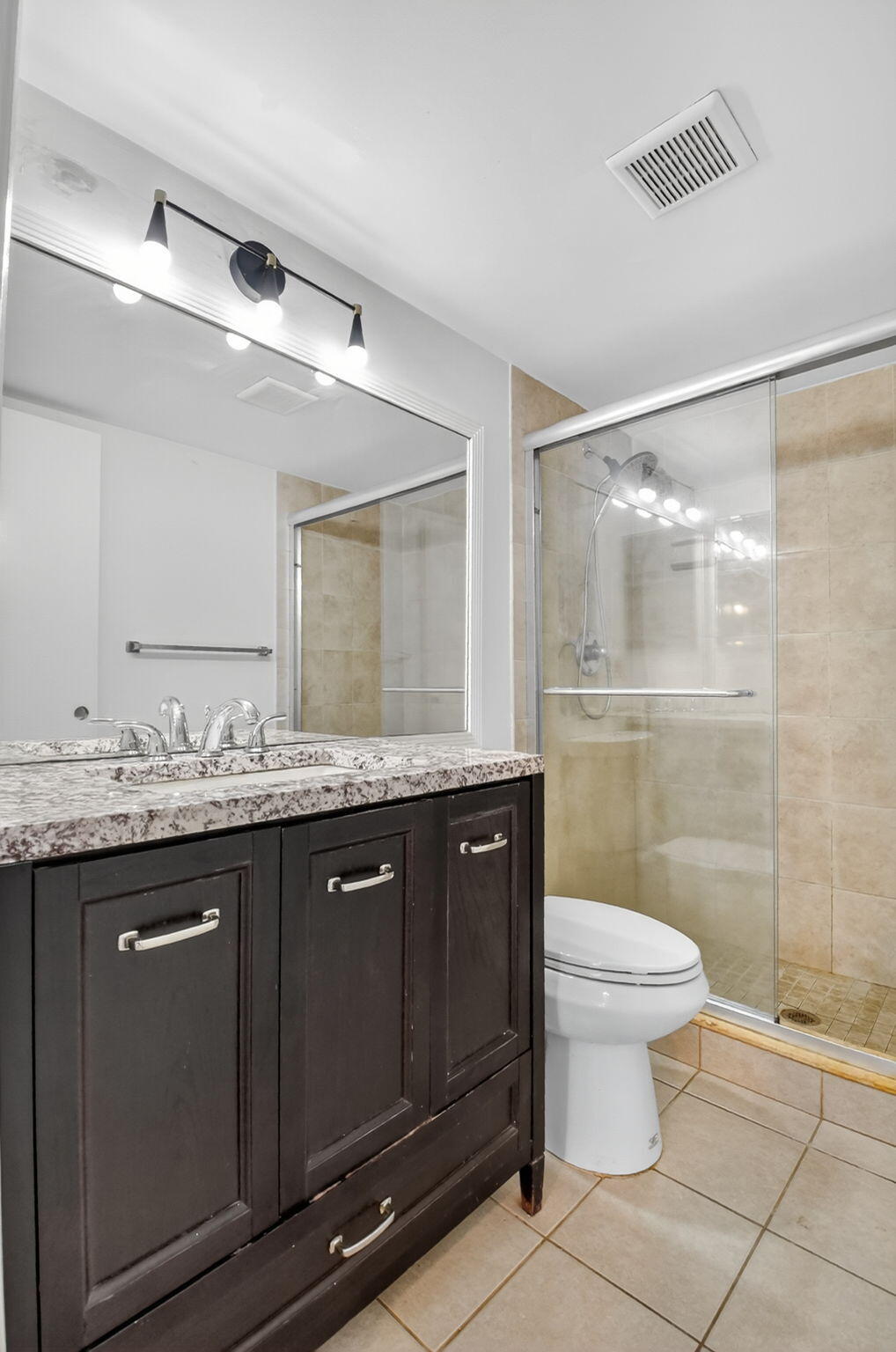 208 Foxtail Drive, Unit B2 Greenacres, FL 33415 - Photo 25 of 33 a bathroom with a granite countertop sink toilet and shower