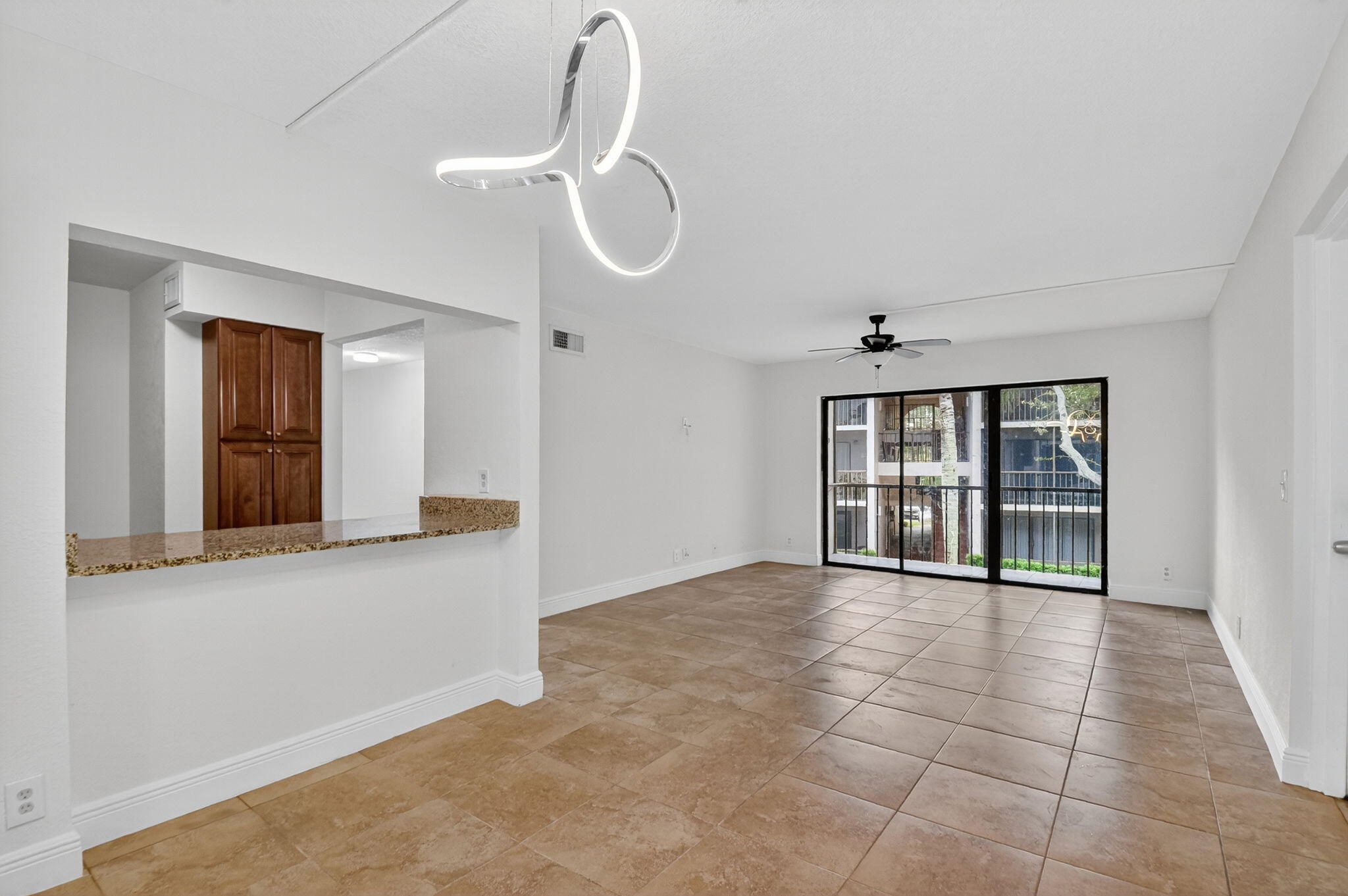 208 Foxtail Drive, Unit B2 Greenacres, FL 33415 - Photo 9 of 33 a view of a room with a large window and chandelier