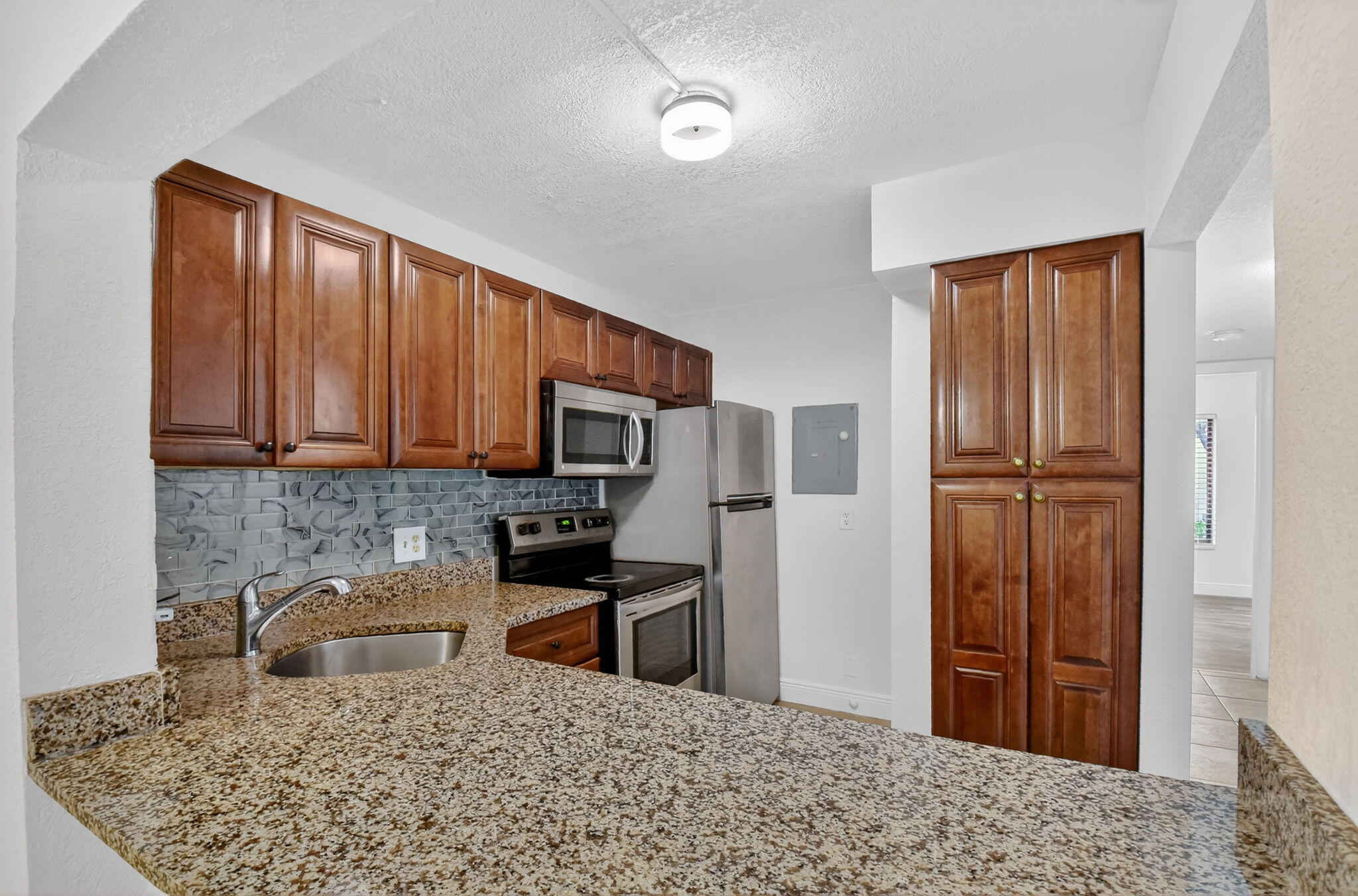 208 Foxtail Drive, Unit B2 Greenacres, FL 33415 - Photo 10 of 33 a kitchen with stainless steel appliances granite countertop a refrigerator sink and stove