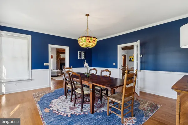 a view of a patio with table and chairs with wooden floor and fence