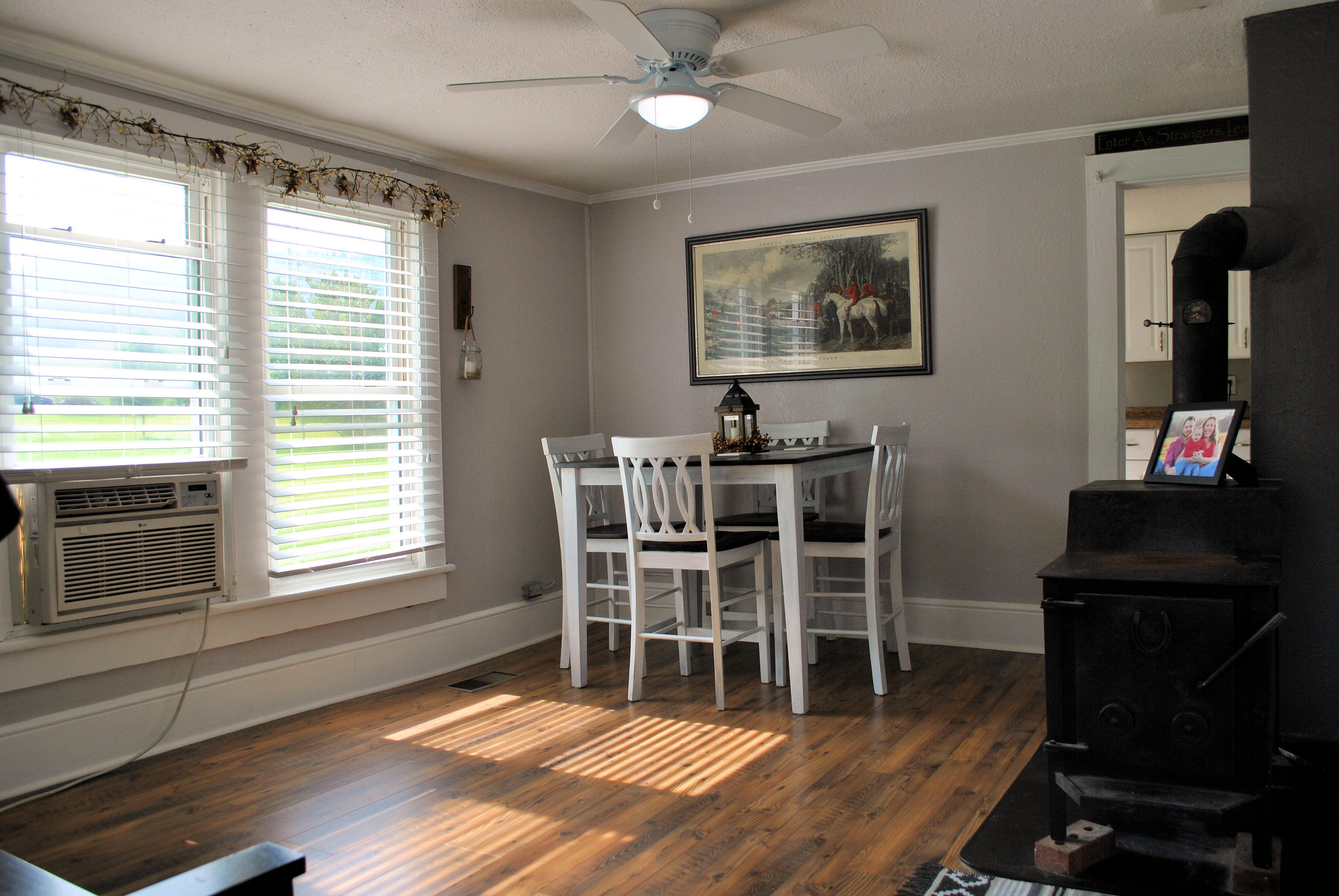 679 Union Valley Road Riner, VA 24149 - Photo 12 of 69 a dining room with wooden floor a chandelier a wooden table and chairs