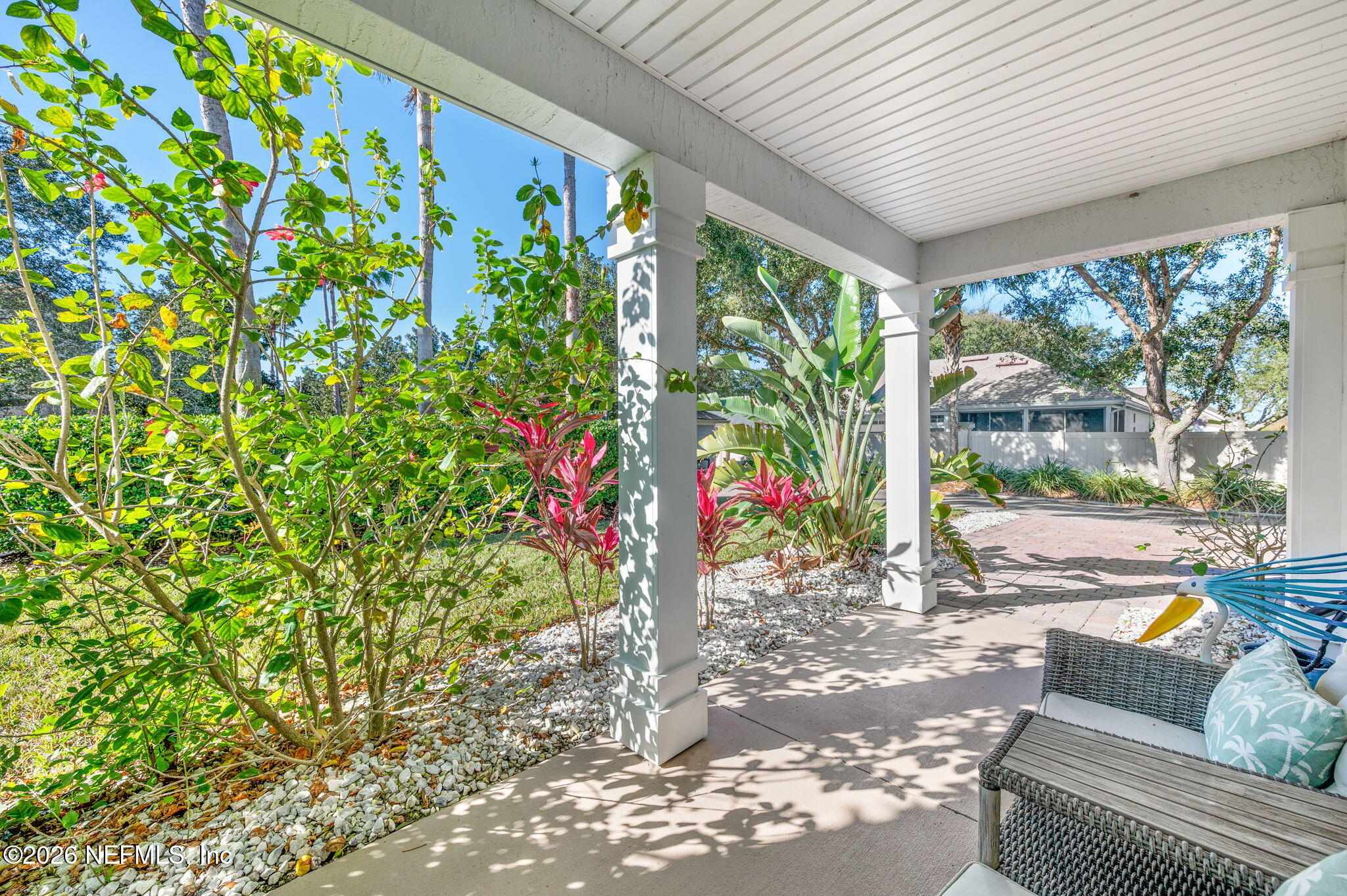 12 Islander Court St. Augustine, FL 32080 - Photo 11 of 53 a porch with a table and chairs and potted plants