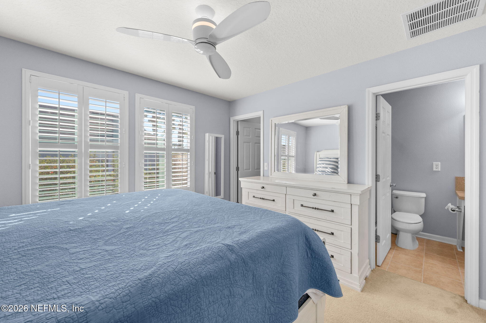 12 Islander Court St. Augustine, FL 32080 - Photo 27 of 53 a spacious bedroom with a large bed and a chandelier