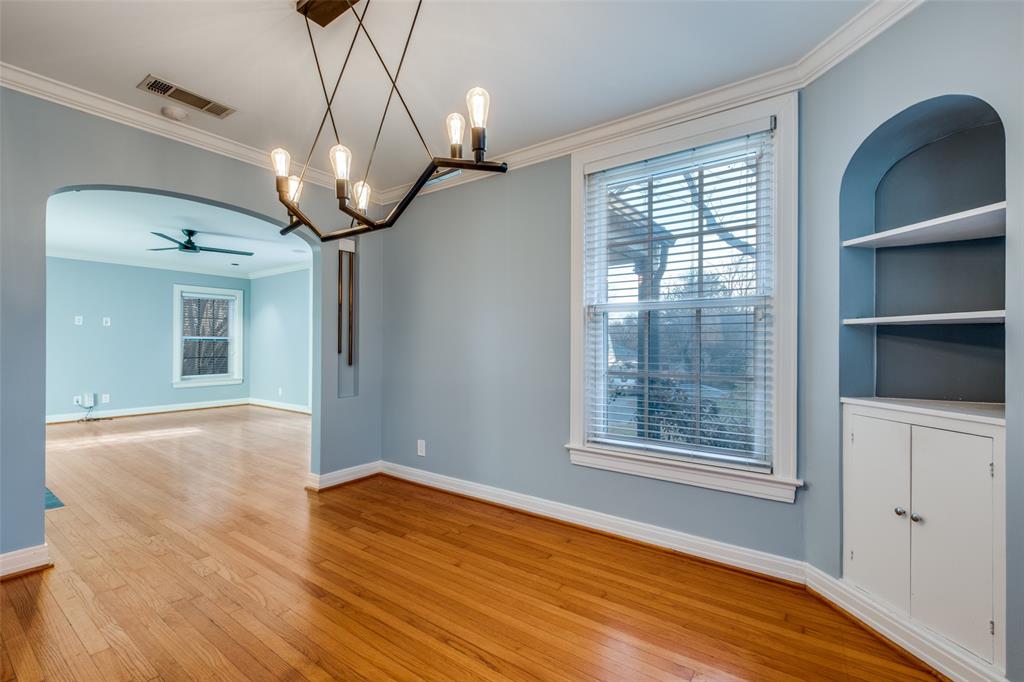 818 Valencia Street Dallas, TX 75223 - Photo 12 of 38 a view of an empty room with wooden floor and a window