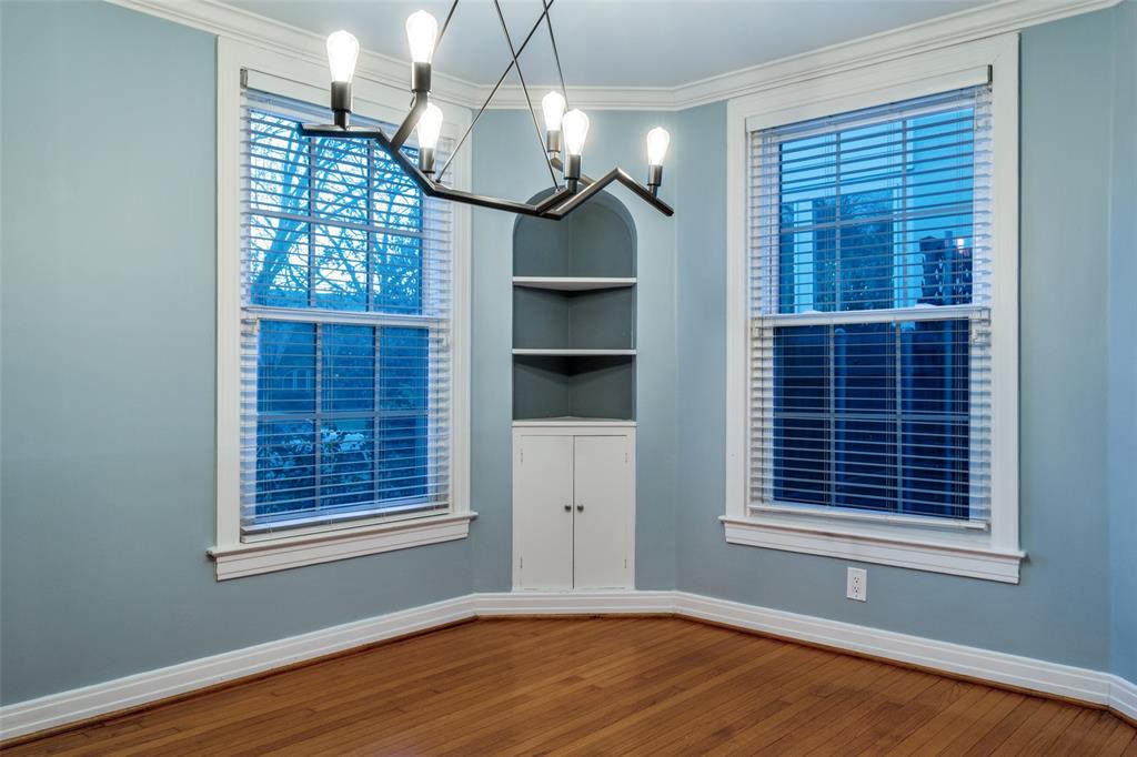 818 Valencia Street Dallas, TX 75223 - Photo 14 of 38 a view of an empty room with a window and wooden floor