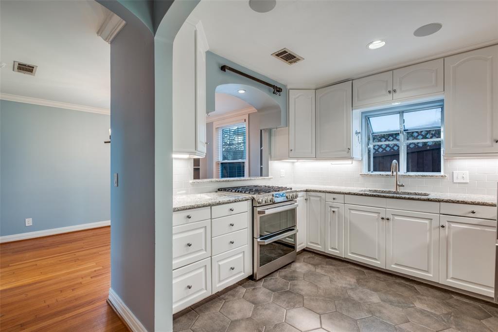 818 Valencia Street Dallas, TX 75223 - Photo 17 of 38 a spacious bathroom with a granite countertop sink and a mirror