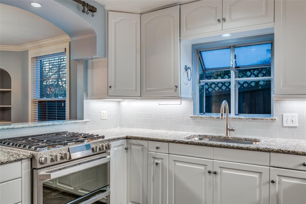 818 Valencia Street Dallas, TX 75223 - Photo 18 of 38 a kitchen with granite countertop a stove a sink and a granite counter tops