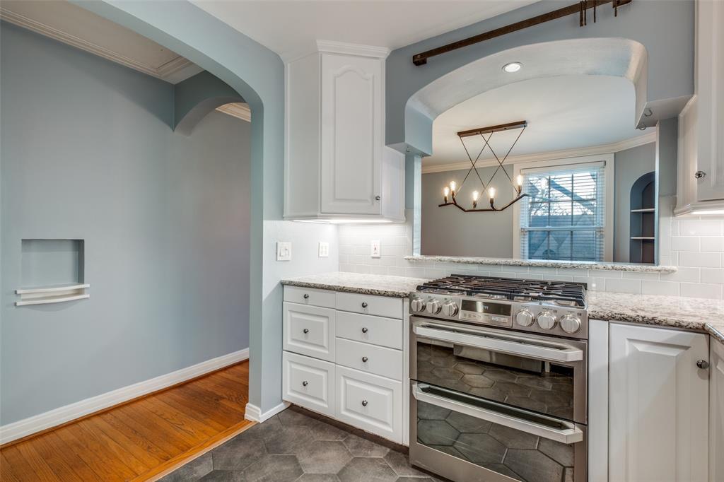 818 Valencia Street Dallas, TX 75223 - Photo 18 of 38 a kitchen with cabinets appliances and a sink