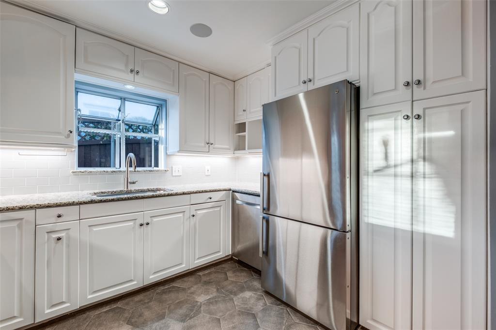 818 Valencia Street Dallas, TX 75223 - Photo 20 of 38 a kitchen with stainless steel appliances granite countertop a refrigerator sink and cabinets