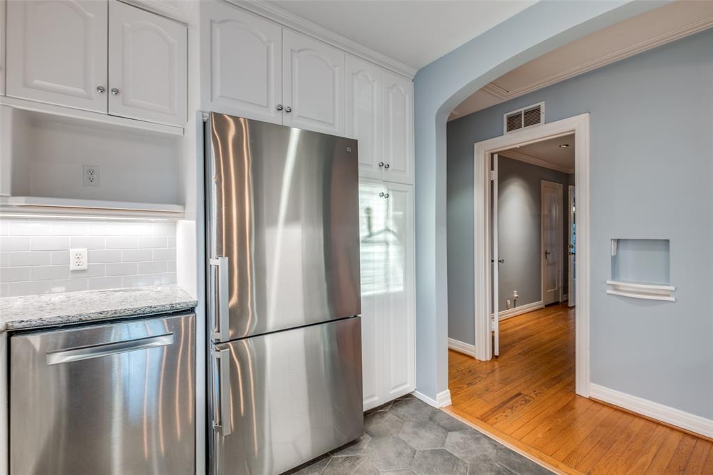 818 Valencia Street Dallas, TX 75223 - Photo 21 of 38 a kitchen with stainless steel appliances granite countertop a refrigerator and a stove