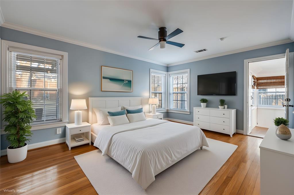 818 Valencia Street Dallas, TX 75223 - Photo 23 of 38 a bedroom with a large bed and a flat screen tv