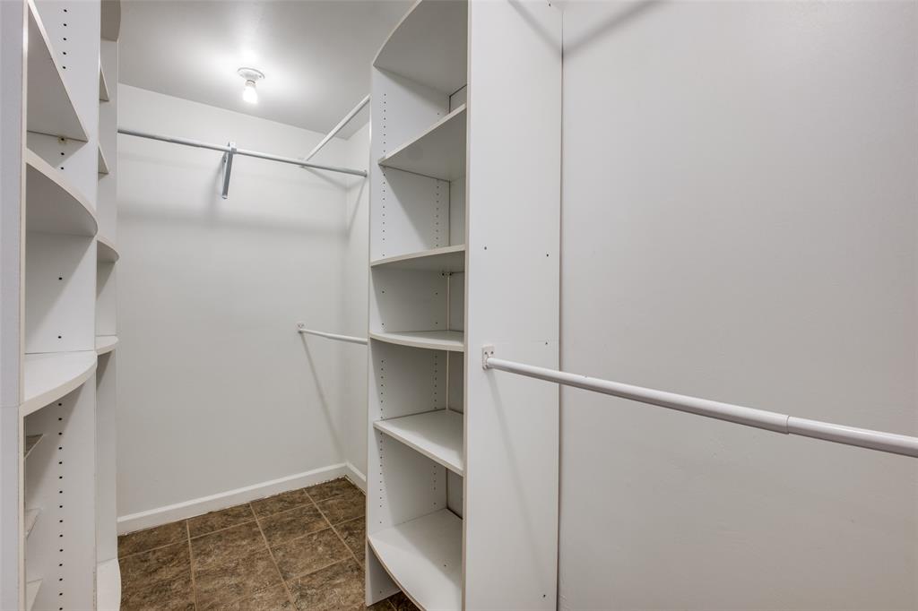 818 Valencia Street Dallas, TX 75223 - Photo 27 of 38 a view of walk in closet with empty racks