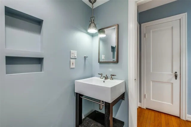 a bathroom with a sink a mirror and a vanity