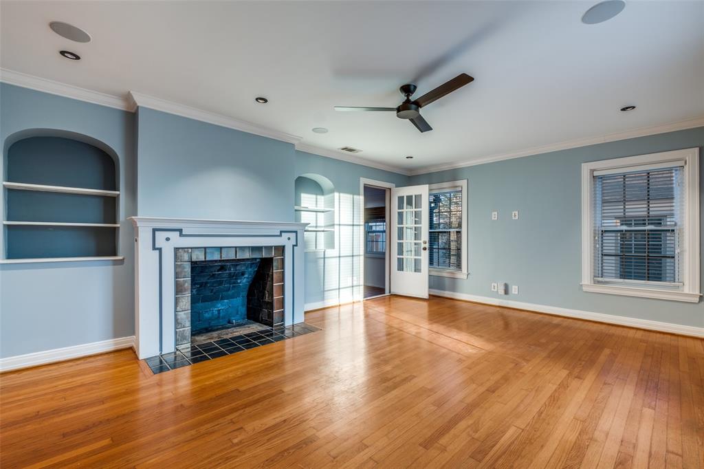 818 Valencia Street Dallas, TX 75223 - Photo 4 of 38 a view of an empty room with wooden floor fireplace and a window