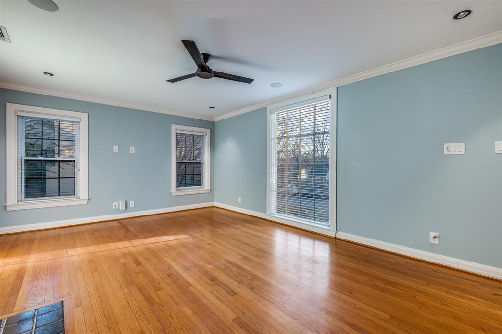 818 Valencia Street Dallas, TX 75223 - Photo 9 of 38 a view of an empty room with wooden floor and a window