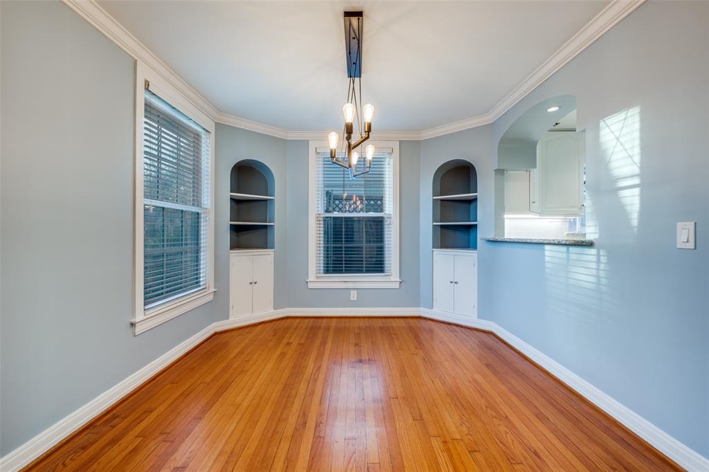 818 Valencia Street Dallas, TX 75223 - Photo 10 of 38 a view of a room with wooden floor chandelier and windows