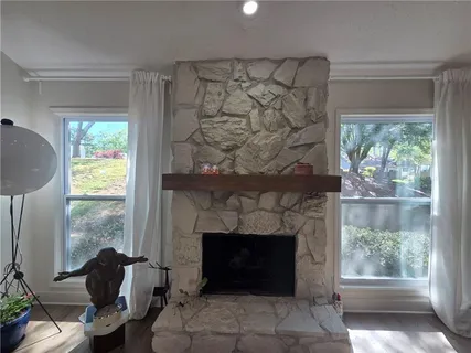 a living room with a fireplace and a window