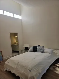 a bedroom with a bed and window