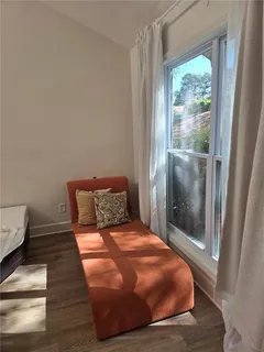 a bed sitting in a bedroom next to a window