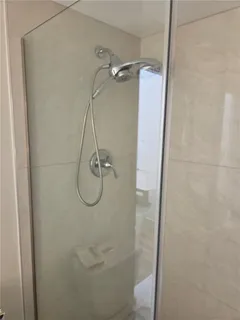 a bathroom with a glass shower door