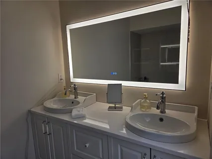 a bathroom with a double vanity sink and a mirror