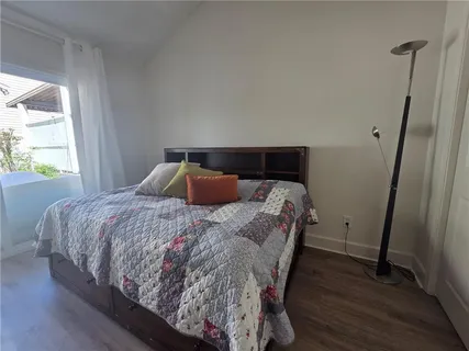 a bed sitting in a bedroom next to a window