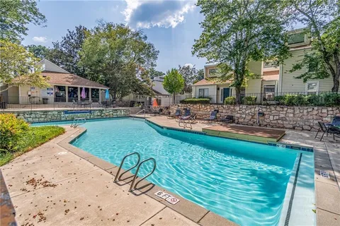 a house with swimming pool in front of it