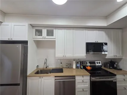 a kitchen with a sink stove and cabinets