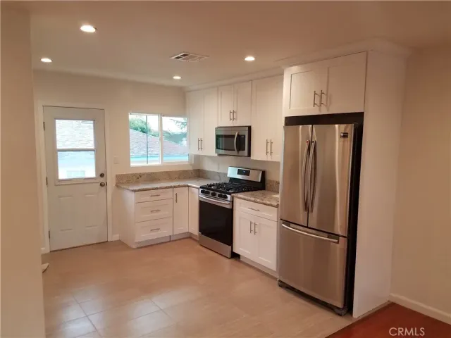 a kitchen with a refrigerator stove and microwave