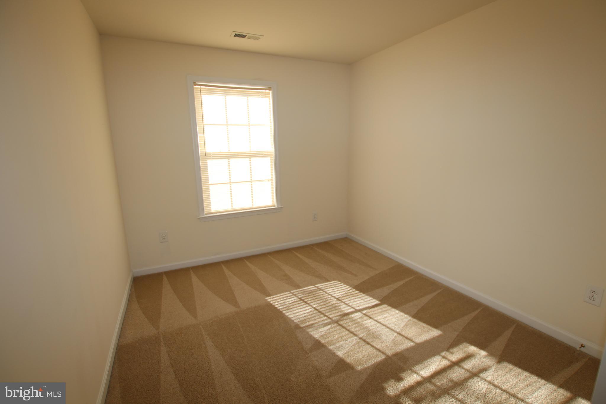 35385 Winthrop Court, Unit B162 Millsboro, DE 19966 - Photo 16 of 18 a view of an empty room and window