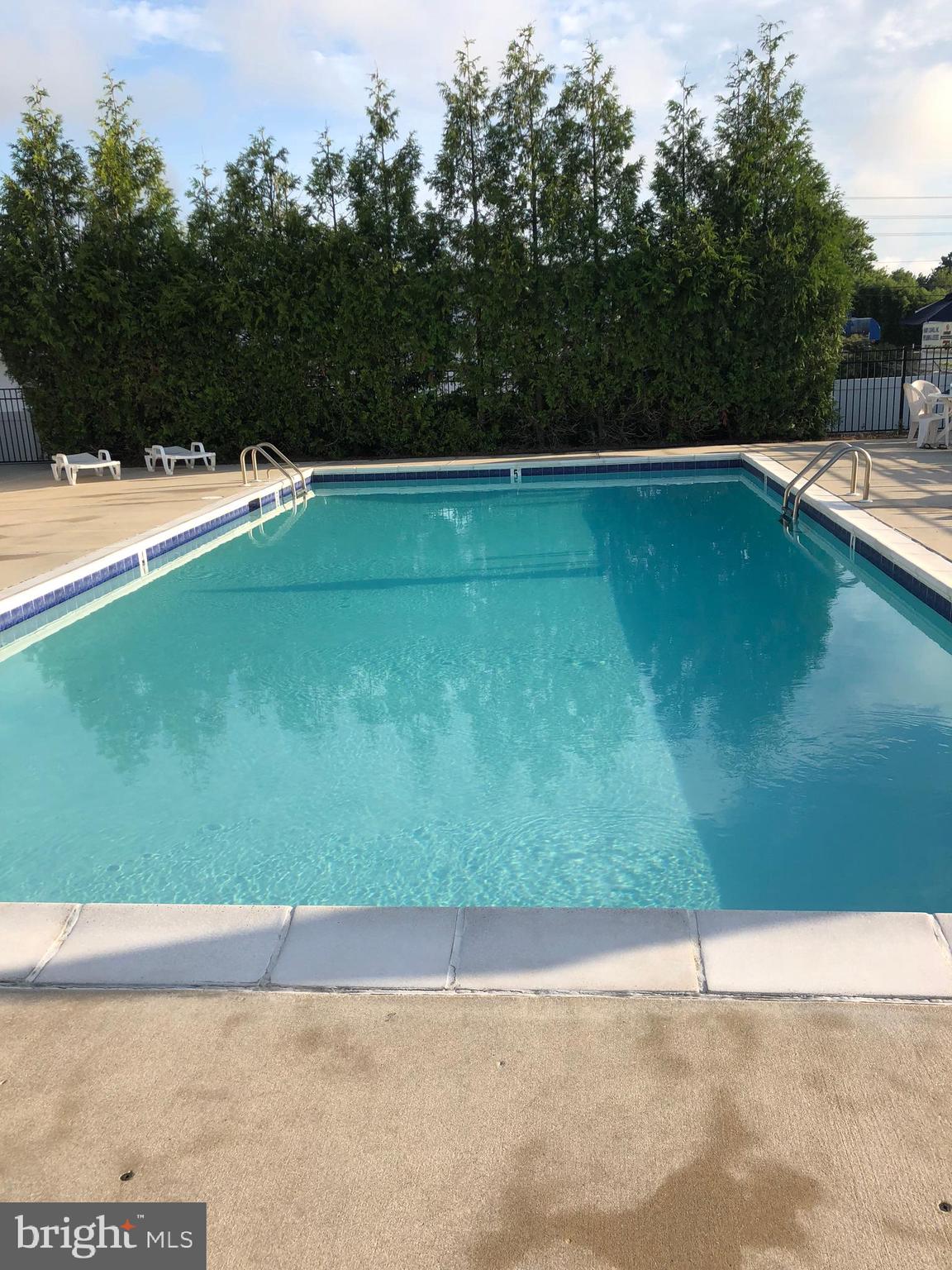 35385 Winthrop Court, Unit B162 Millsboro, DE 19966 - Photo 2 of 18 a view of a swimming pool and an outdoor space