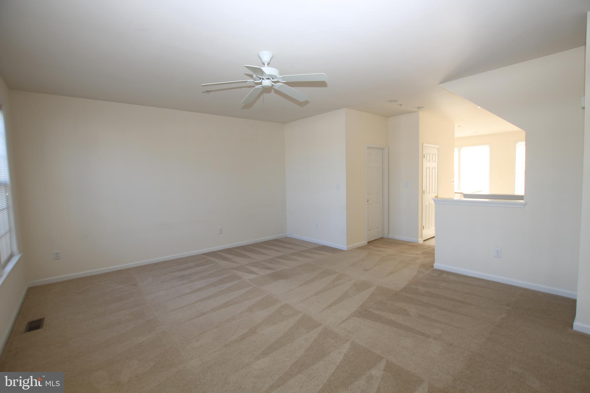 35385 Winthrop Court, Unit B162 Millsboro, DE 19966 - Photo 4 of 18 an empty room with windows and fan