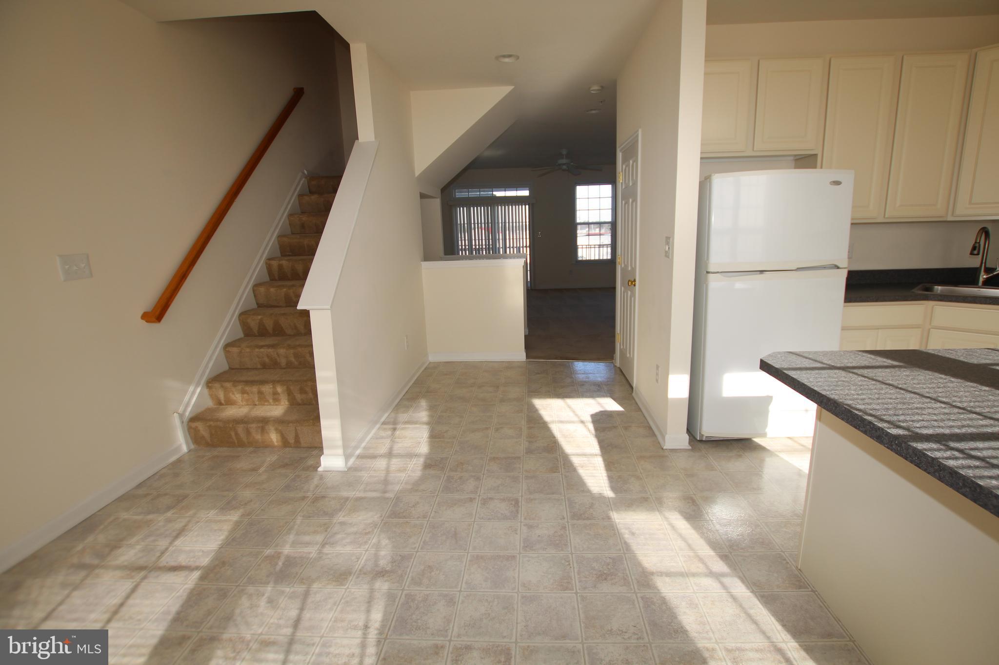 35385 Winthrop Court, Unit B162 Millsboro, DE 19966 - Photo 9 of 18 a view of a kitchen with a refrigerator and a stove