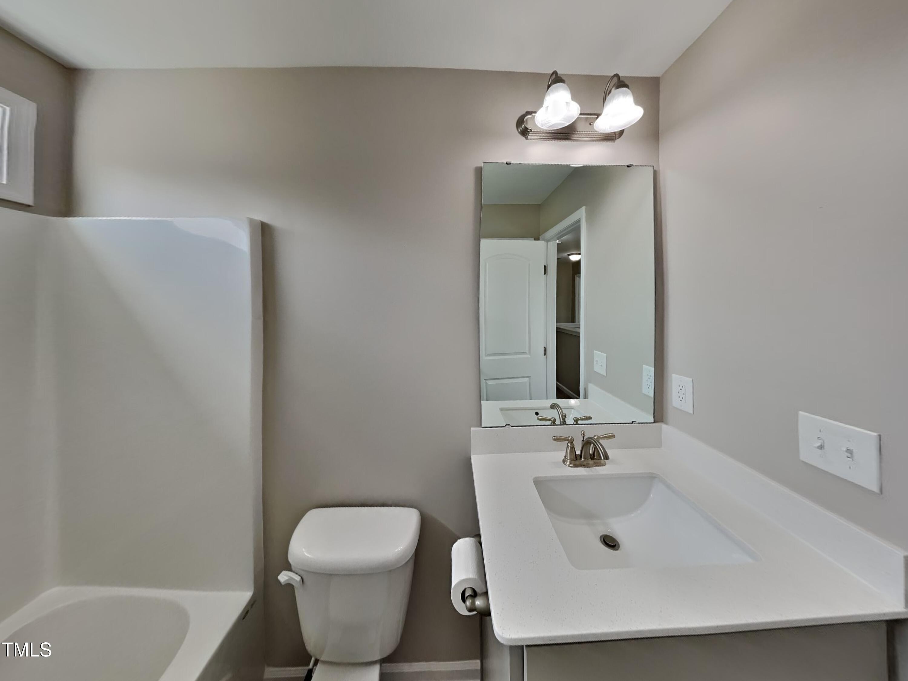 376 Olde Place Drive Zebulon, NC 27597 - Photo 14 of 16 a bathroom with a sink and a mirror
