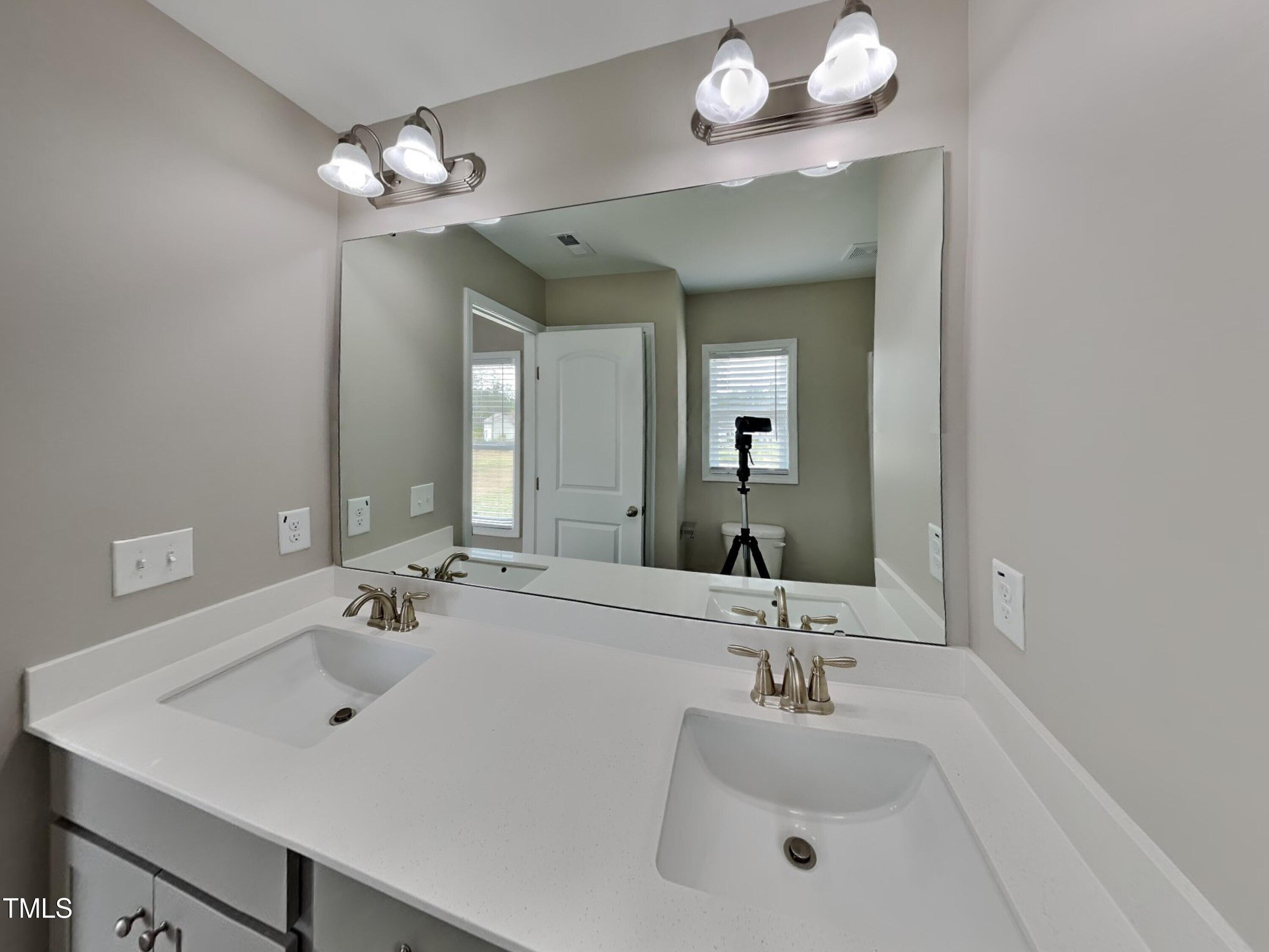 376 Olde Place Drive Zebulon, NC 27597 - Photo 9 of 16 a bathroom with a sink vanity and a mirror