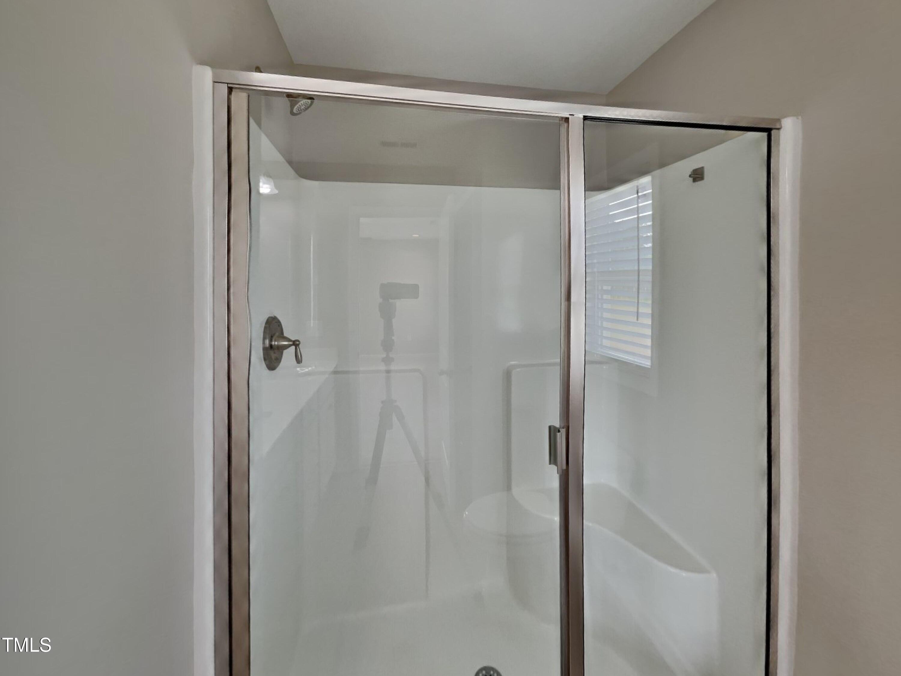 376 Olde Place Drive Zebulon, NC 27597 - Photo 10 of 16 a bathroom with a glass shower door