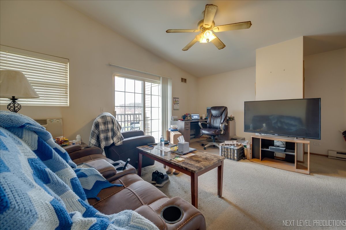 1506 Spring Brook Court, Unit 2A Round Lake Beach, IL 60073 - Photo 12 of 13 a living room with furniture and a flat screen tv