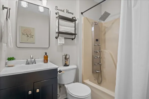 a bathroom with a sink toilet and shower