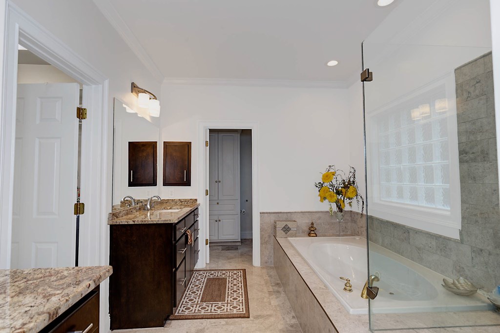 7633 Grand Ridge Road Columbus, GA 31904 - Photo 16 of 61 a bathroom with a tub sink and mirror