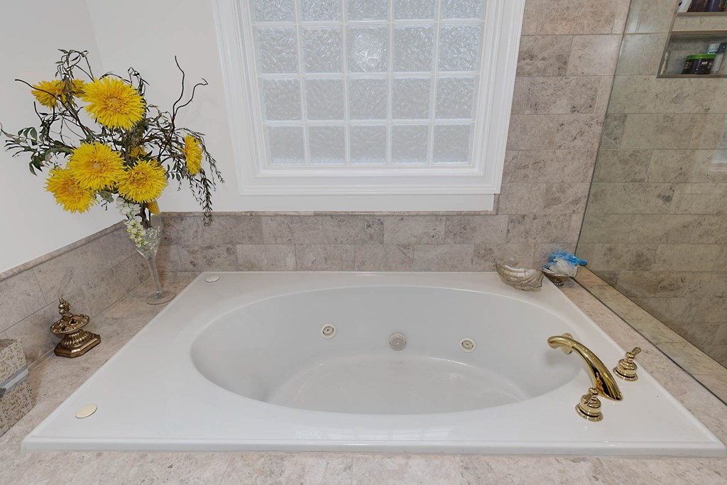 7633 Grand Ridge Road Columbus, GA 31904 - Photo 18 of 61 a bath tub sitting next to a blue sink