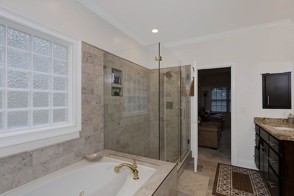 7633 Grand Ridge Road Columbus, GA 31904 - Photo 19 of 61 a bathroom with a tub a sink and a shower
