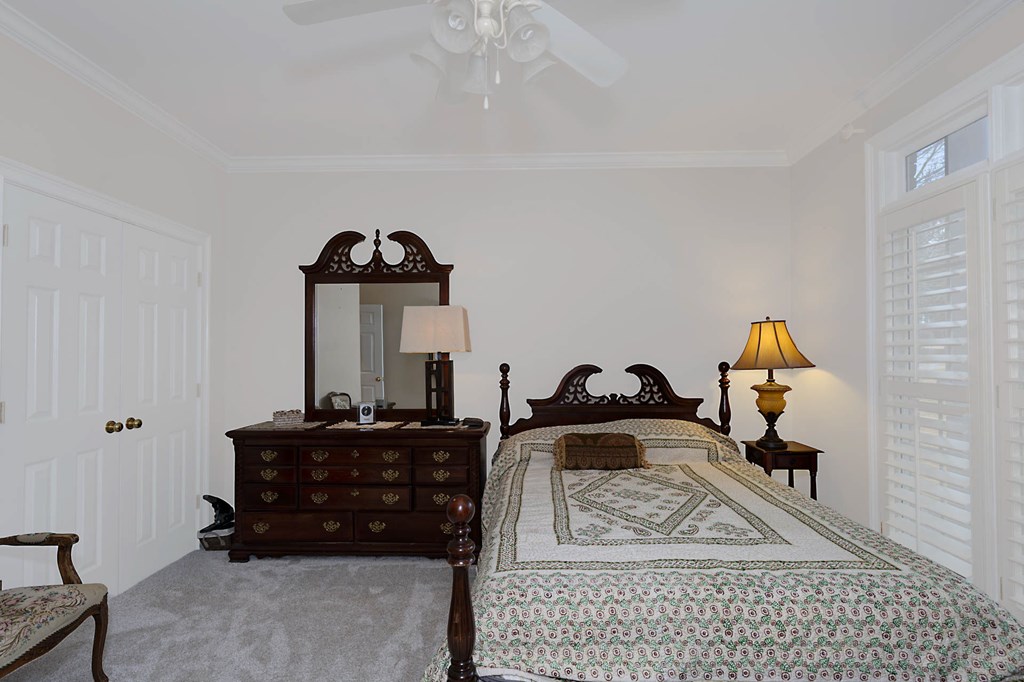 7633 Grand Ridge Road Columbus, GA 31904 - Photo 21 of 61 a living room with a bed a couch and dresser