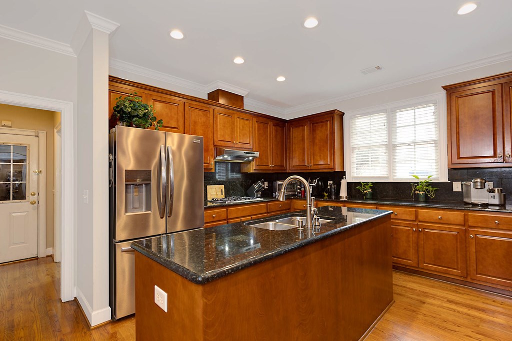 7633 Grand Ridge Road Columbus, GA 31904 - Photo 31 of 61 a kitchen with stainless steel appliances granite countertop a refrigerator a sink a stove and island