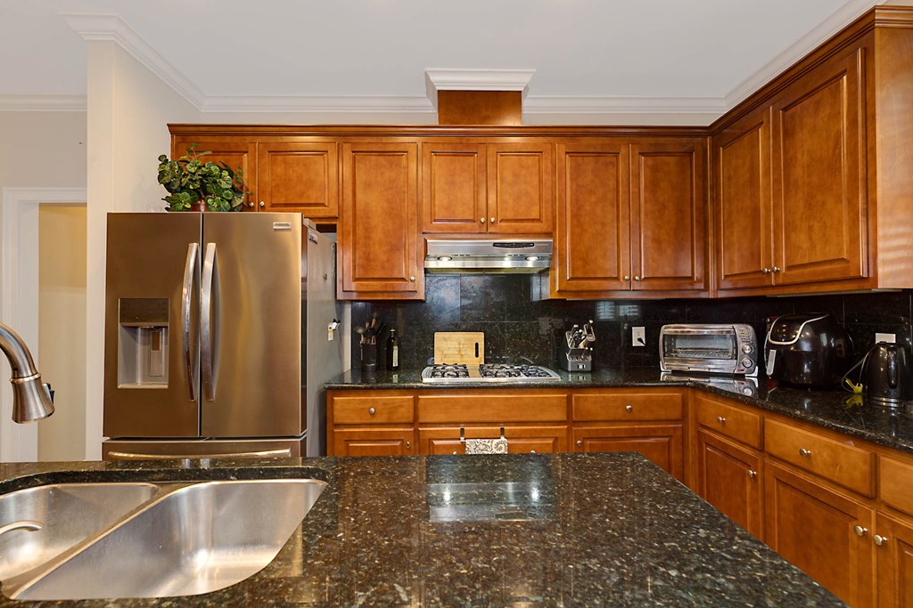 7633 Grand Ridge Road Columbus, GA 31904 - Photo 32 of 61 a kitchen with stainless steel appliances granite countertop a refrigerator and a sink