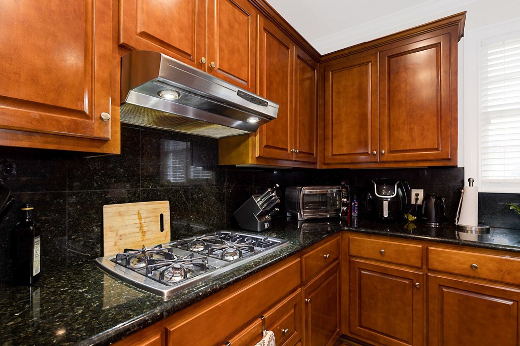 7633 Grand Ridge Road Columbus, GA 31904 - Photo 33 of 61 a kitchen with stainless steel appliances granite countertop a stove and cabinets