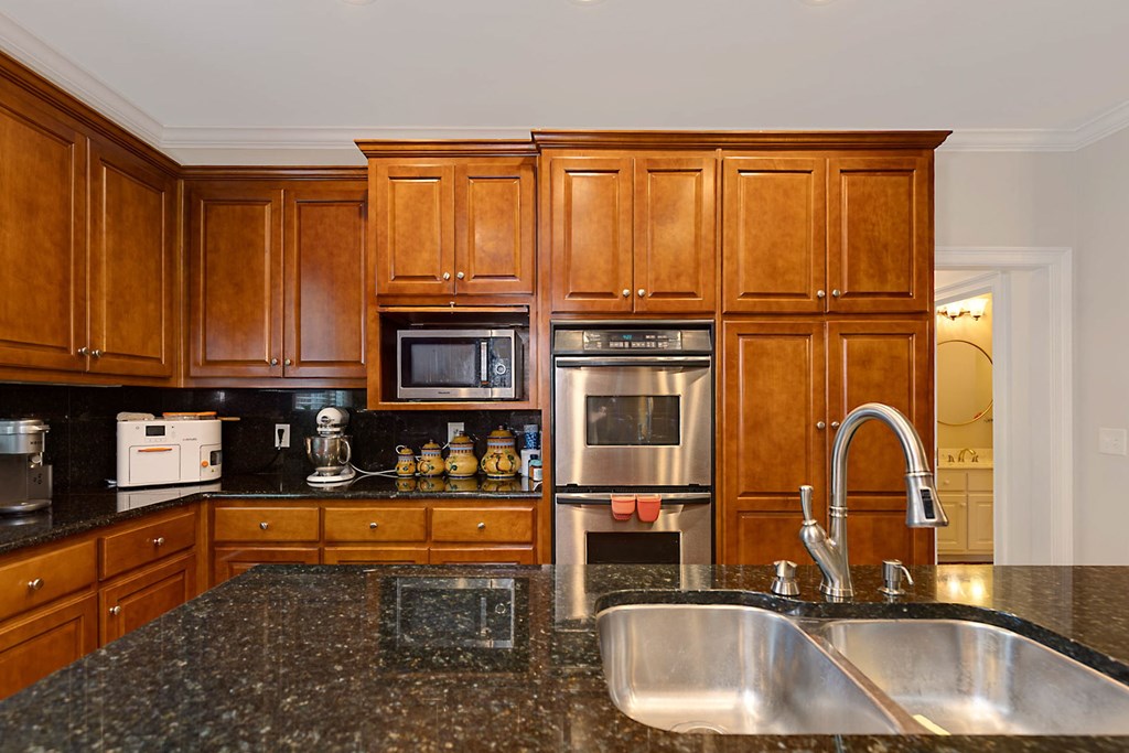 7633 Grand Ridge Road Columbus, GA 31904 - Photo 34 of 61 a kitchen with granite countertop a sink and a refrigerator
