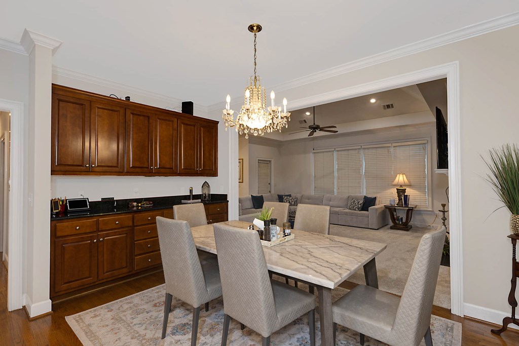 7633 Grand Ridge Road Columbus, GA 31904 - Photo 36 of 61 a view of a dining room with furniture and chandelier